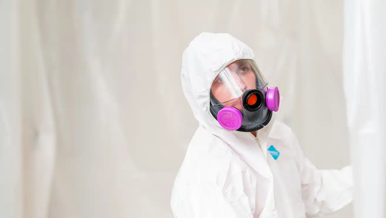 Rainbow Restoration professional wearing a protective suit and respirator during mold assessment and remediation