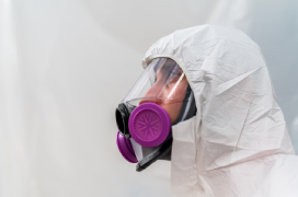 Restoration professional in a biohazard cleaning suit.