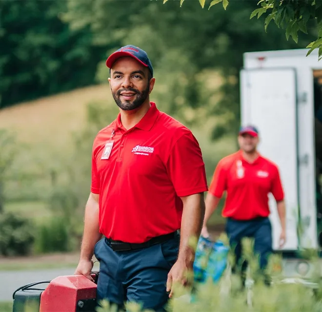 A team from Rainbow Restoration of Dickinson carries equipment into a property after responding to a call for restoration services in Manvel, TX.