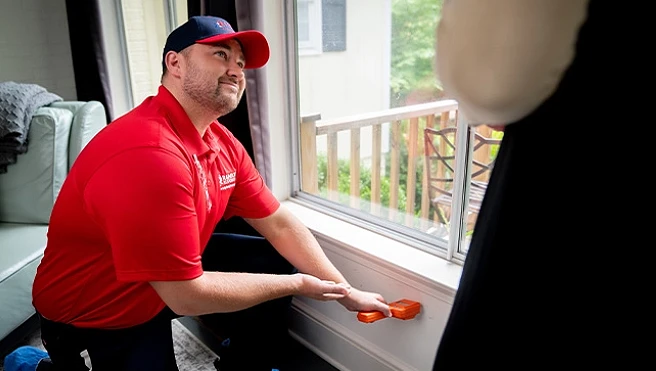 A Rainbow Restoration expert checks for water damage in a wall at a North Charleston, SC, home using a moisture meter.