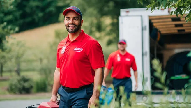 A team from Rainbow Restoration of Greenville carries equipment into a property after responding to a call for restoration services in Powdersville, SC.