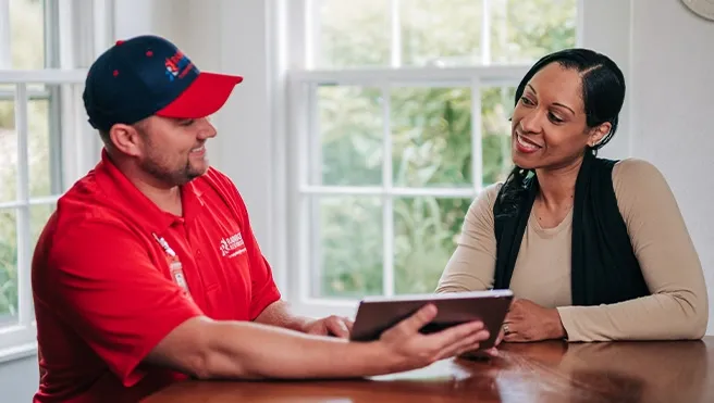A Rainbow Restoration representative discusses property restoration services with a homeowner in Hardeeville, SC.