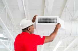 Rainbow Restoration professional cleaning an air duct.