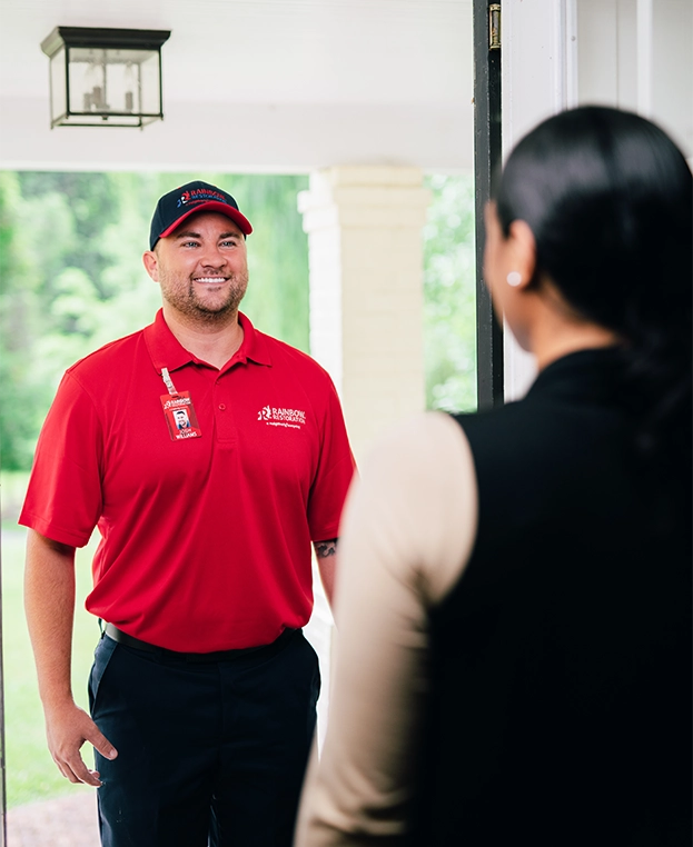 Rainbow Restoration professional greeting customer at front door.