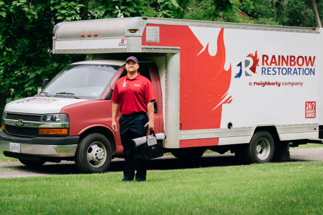 A Rainbow Restoration service professional talks to a customer about their recommendations after a sewage cleanup.