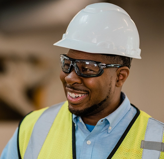 Rainbow Restoration expert smiling with hard hat and goggles.