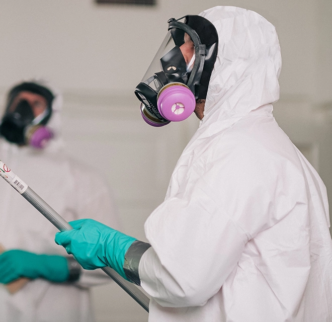 Rainbow Restoration technician wearing a hazmat suit.