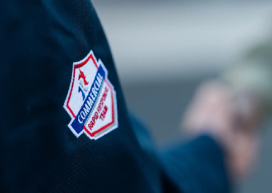 Rainbow Restoration logo badge on a service professional’s uniform.