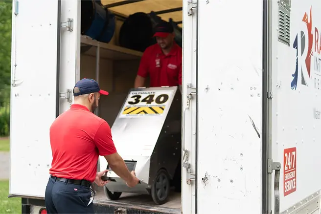 Rainbow Restoration of Dickinson technicians unload water damage equipment at a residential property damage loss in Pearland, TX.