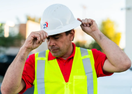 Rainbow Restoration service professional puts on a hard hat.