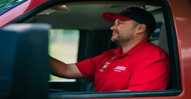 Restoration professional driving a vehicle in Marietta, GA.