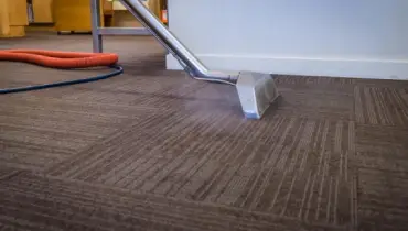 Steam cleaning being used to clean a carpet.