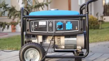 Gasoline powered portable generator in from of residential home.
