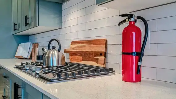 Fire extinguisher on kitchen countertop.