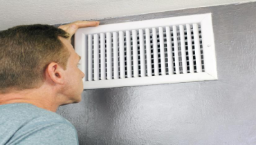 Man Doing Spring Air Duct Cleaning